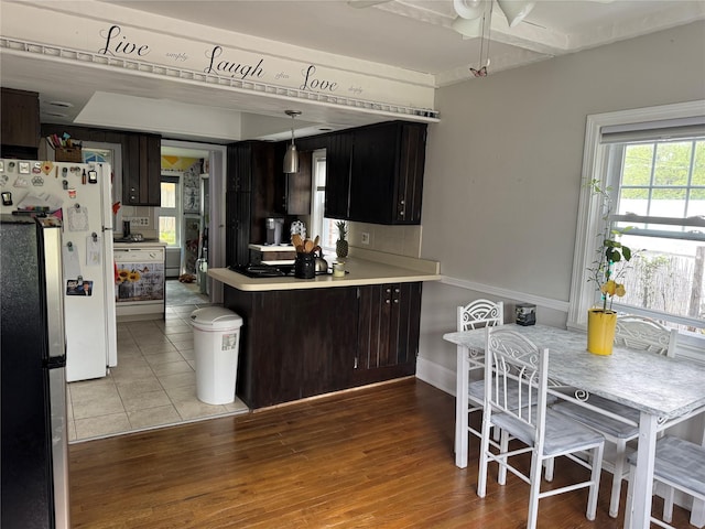 5 W Stone St, Newburgh, NY 12550 - kitchen featuring freestanding refrigerator, a ceiling fan, light countertops, and a peninsula