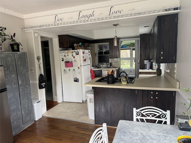 5 W Stone St, Newburgh, NY 12550 - kitchen featuring freestanding refrigerator, wood finished floors, stovetop, and a peninsula