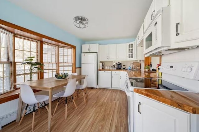 7181 County Highway 7, Roscoe, NY 12776 - kitchen with white appliances, light wood finished floors, white cabinets, and glass insert cabinets