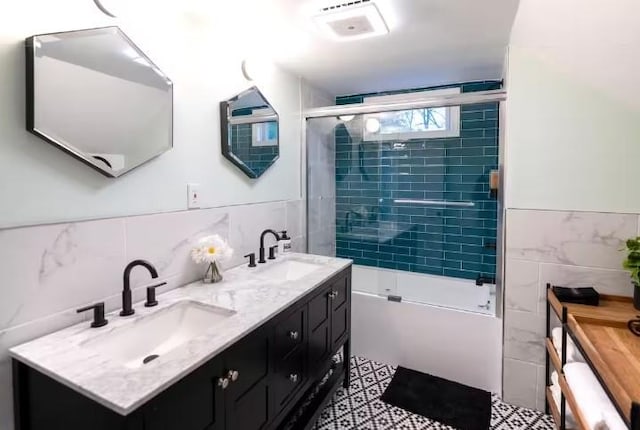 7181 County Highway 7, Roscoe, NY 12776 - full bathroom featuring tile walls, double vanity, and bath / shower combo with glass door