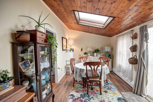 21 Potter Ln, Levittown, NY 11756 - dining space featuring wooden ceiling, a skylight, a baseboard radiator, wood finished floors, and baseboards