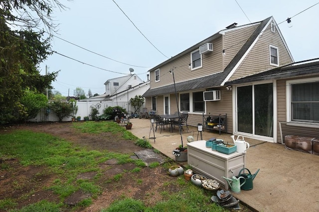 21 Potter Ln, Levittown, NY 11756 - rear view of property featuring an AC wall unit, a patio, and fence