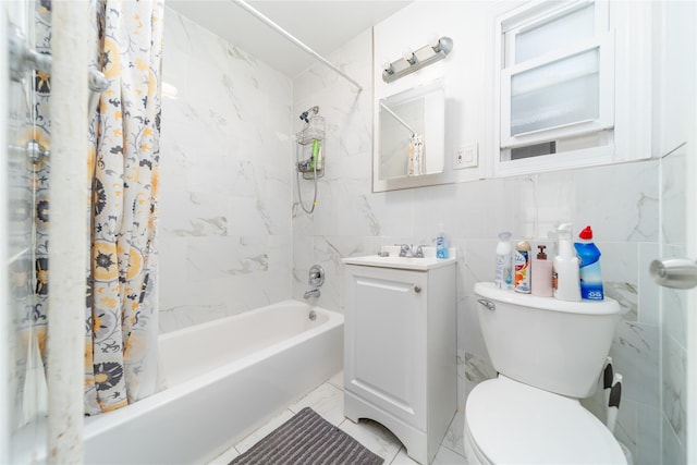 bathroom featuring tile walls, vanity, toilet, marble finish floor, and shower / tub combo with curtain