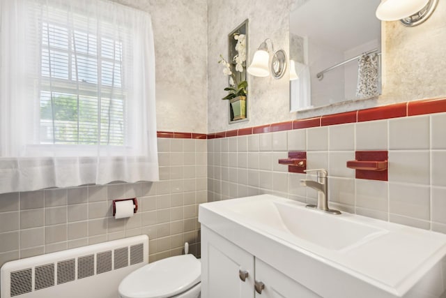 full bathroom with curtained shower, tile walls, radiator, and toilet