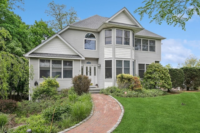 91 Soundview Dr, Rocky Point, NY 11778 - victorian home featuring a front lawn, a shingled roof, and french doors