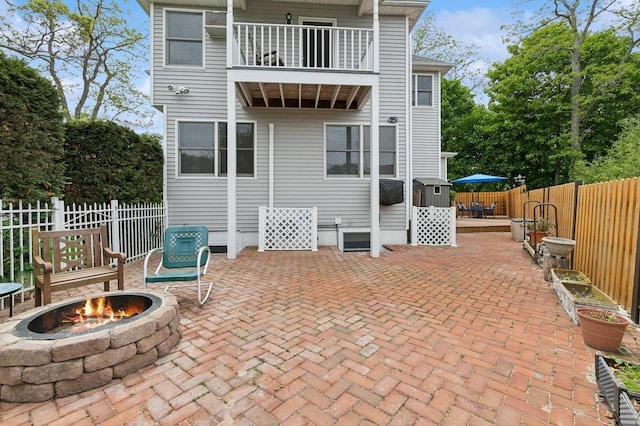 91 Soundview Dr, Rocky Point, NY 11778 - back of property with an outdoor fire pit, a balcony, fence, and a patio