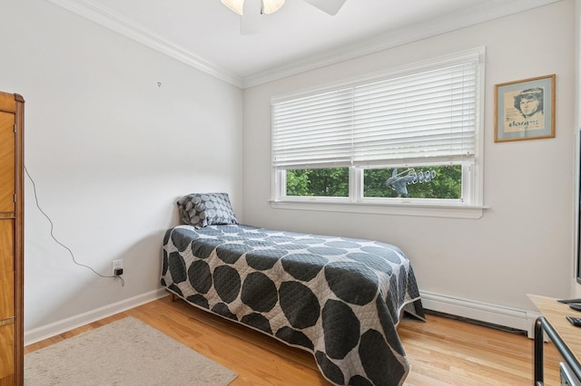 91 Soundview Dr, Rocky Point, NY 11778 - bedroom with a baseboard heating unit, wood finished floors, crown molding, baseboards, and ceiling fan
