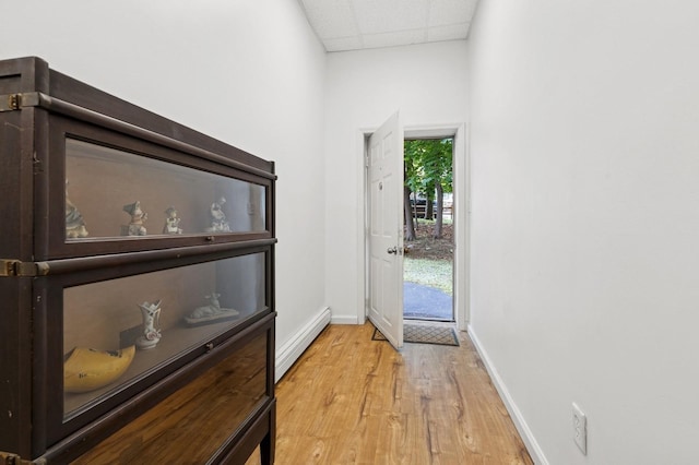 91 Soundview Dr, Rocky Point, NY 11778 - doorway with baseboards, light wood finished floors, a drop ceiling, and baseboard heating
