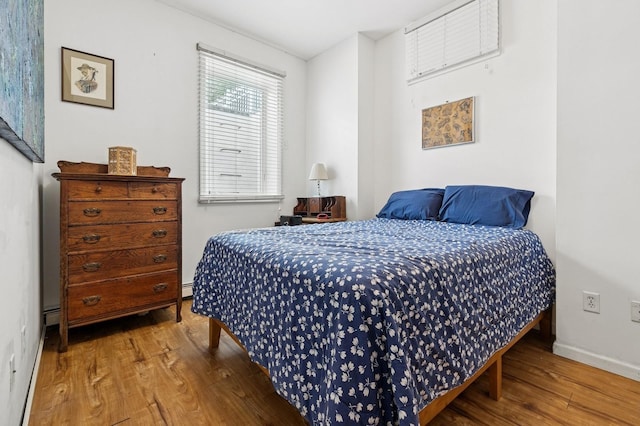 91 Soundview Dr, Rocky Point, NY 11778 - bedroom featuring wood finished floors, baseboards, and a baseboard radiator