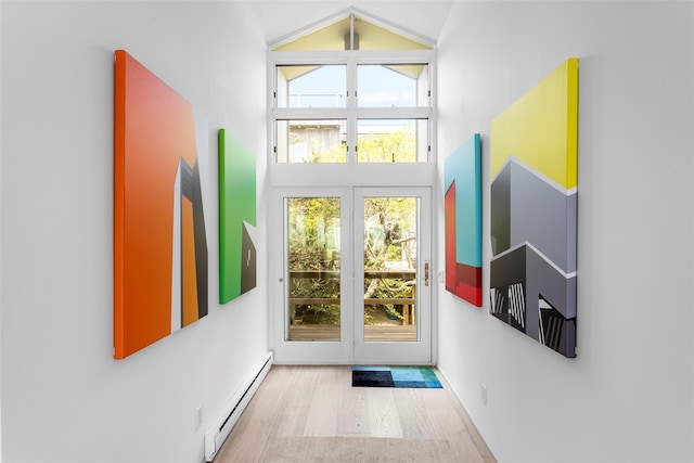 592 Ocean Walk, Fire Island Pines, NY 11782 - doorway with baseboard heating, high vaulted ceiling, wood finished floors, and healthy amount of natural light