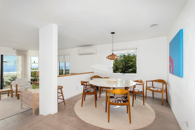 592 Ocean Walk, Fire Island Pines, NY 11782 - dining room with plenty of natural light, wood finished floors, and a wall mounted AC