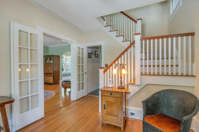 65 Hamilton Pl, Tarrytown, NY 10591 - stairs featuring french doors, wood finished floors, and baseboards