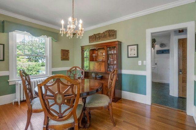 65 Hamilton Pl, Tarrytown, NY 10591 - dining room with crown molding, a chandelier, wood finished floors, and baseboards