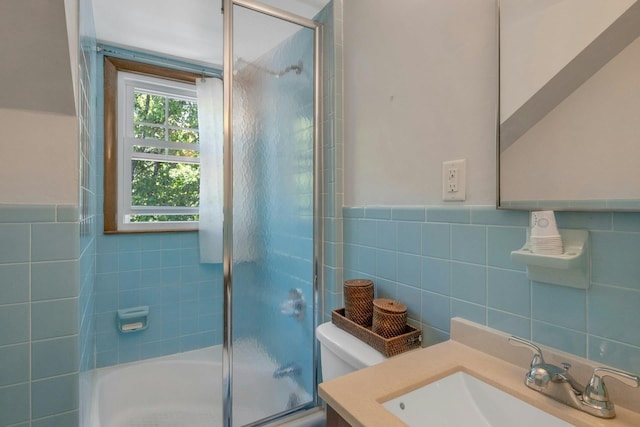 65 Hamilton Pl, Tarrytown, NY 10591 - full bathroom featuring tile walls, toilet, vanity, bath / shower combo with glass door, and a wainscoted wall