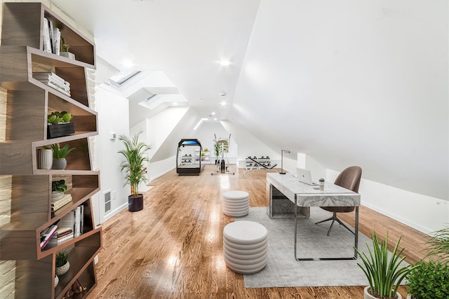 office area featuring baseboards, visible vents, wood finished floors, and lofted ceiling