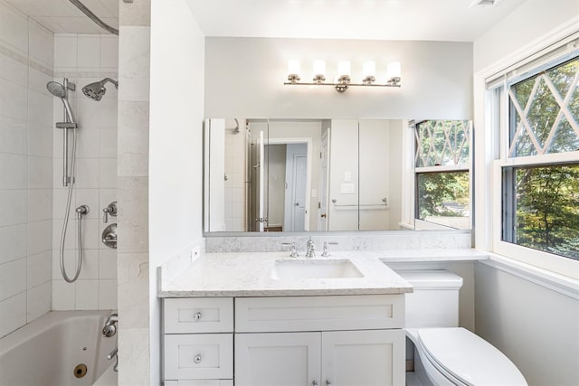 full bath featuring a combined bath / shower with jetted tub, vanity, and toilet
