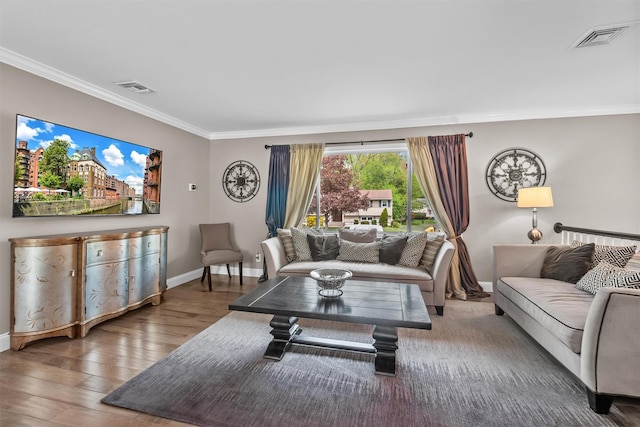 living room with crown molding, visible vents, and baseboards