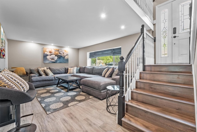 living area with stairway, recessed lighting, and wood finished floors
