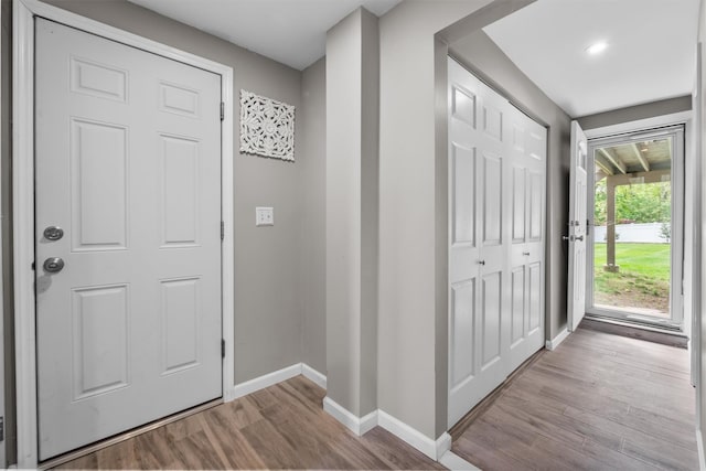 entryway with baseboards and wood finished floors