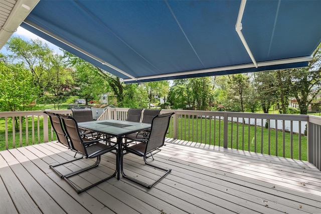 wooden deck featuring a yard and outdoor dining area