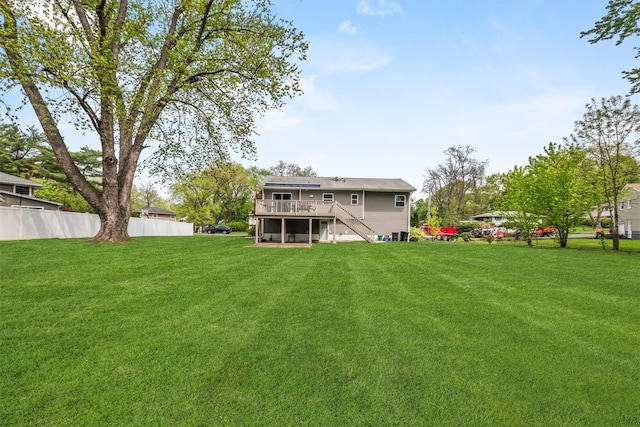 rear view of house featuring a yard, stairway, fence, and a wooden deck