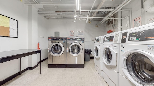 shared laundry area featuring tile patterned floors and washing machine and clothes dryer