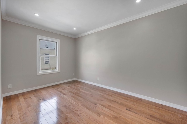 empty room featuring baseboards, ornamental molding, light wood-style flooring, and recessed lighting