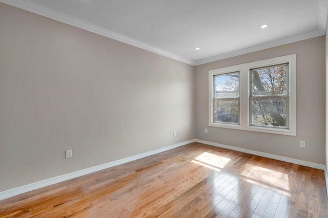 spare room with crown molding, light wood-style floors, baseboards, and recessed lighting