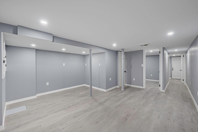 finished basement with baseboards, recessed lighting, and visible vents