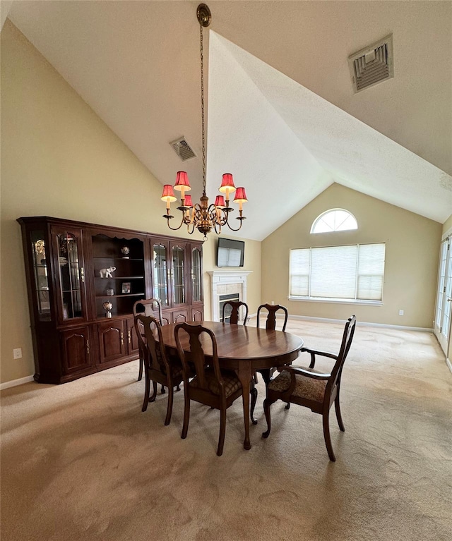 carpeted dining space featuring vaulted ceiling, a fireplace, a chandelier, healthy amount of natural light, and baseboards