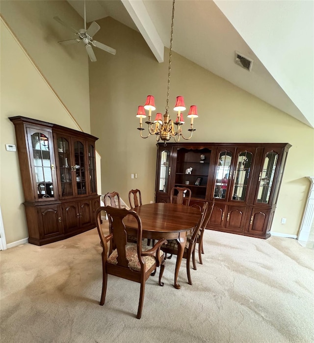dining room featuring light carpet, a chandelier, ceiling fan, high vaulted ceiling, and baseboards