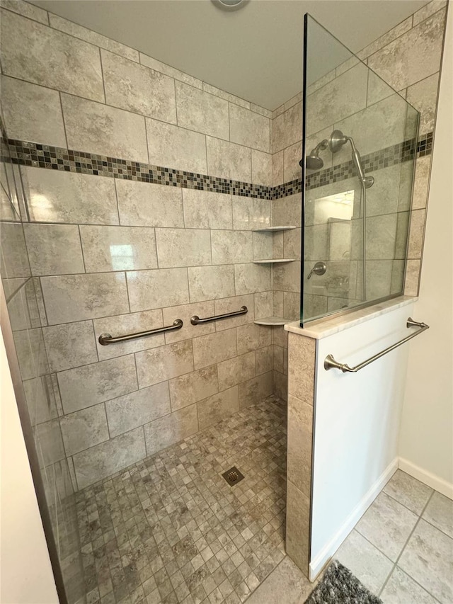 full bathroom featuring walk in shower, baseboards, and tile patterned floors