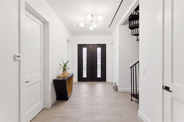 894 S Long Beach Ave, Freeport, NY 11520 - entrance foyer with light wood-style floors, a chandelier, and french doors