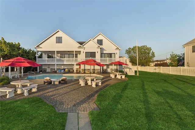 894 S Long Beach Ave, Freeport, NY 11520 - rear view of property with a balcony, a patio area, and an outdoor pool