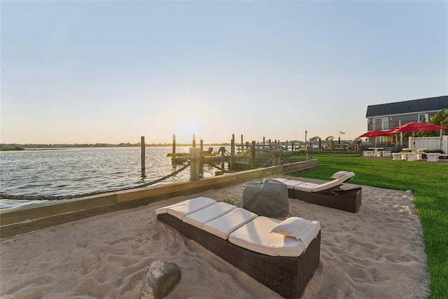 894 S Long Beach Ave, Freeport, NY 11520 - patio terrace at dusk featuring a water view, a lawn, and a boat dock