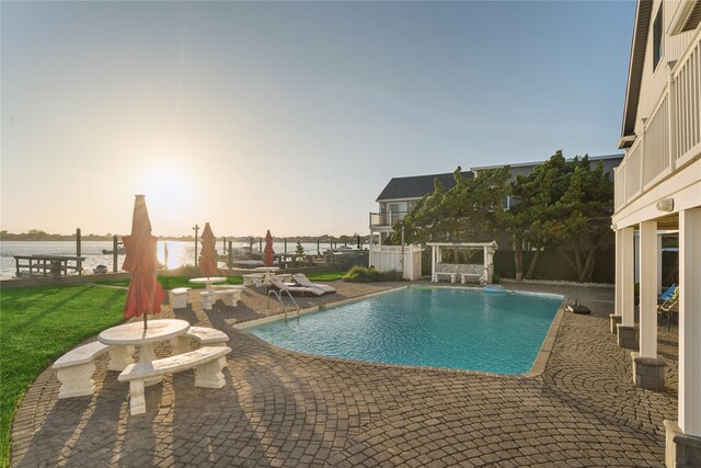894 S Long Beach Ave, Freeport, NY 11520 - pool at dusk with a patio area, a fenced backyard, and a water view