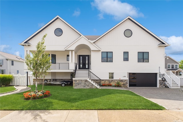 894 S Long Beach Ave, Freeport, NY 11520 - view of front facade with stairs, driveway, a garage, and a porch