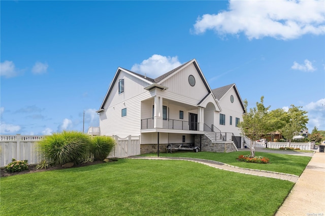 894 S Long Beach Ave, Freeport, NY 11520 - view of front of property with board and batten siding, stairway, and stone siding