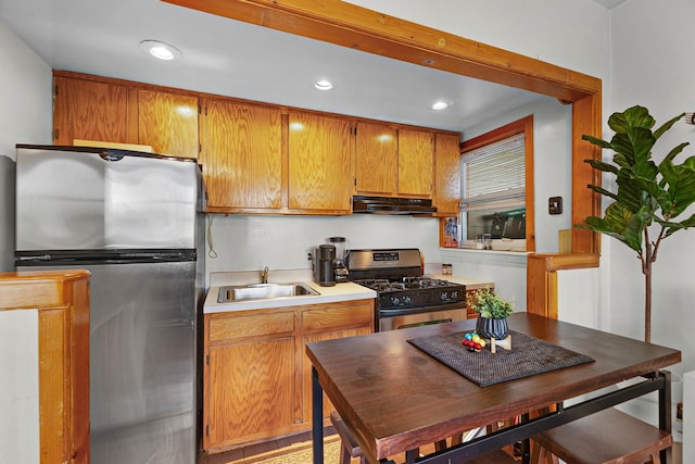 63 Laurel Pl, Yonkers, NY 10704 - kitchen with a sink, under cabinet range hood, light countertops, appliances with stainless steel finishes, and recessed lighting