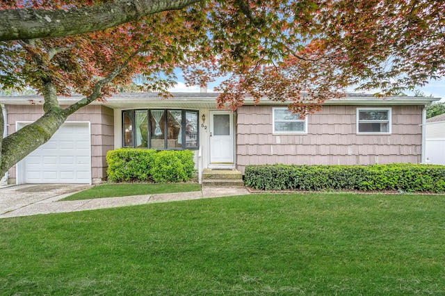 ranch-style home with a front lawn, concrete driveway, and a garage