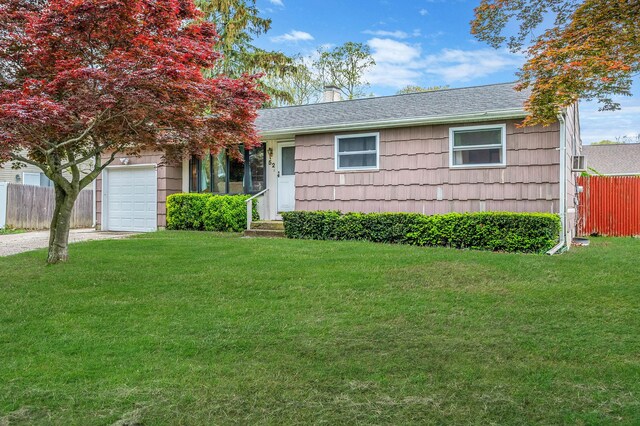 view of front of house featuring a chimney, an attached garage, driveway, and a shingled roof