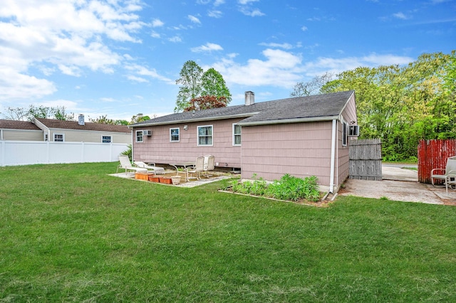 rear view of house with a patio, roof with shingles, and a chimney
