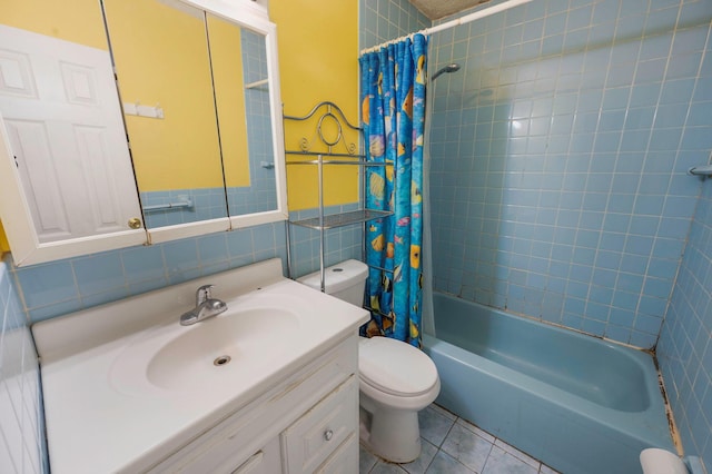 bathroom featuring tile walls, toilet, shower / bathtub combination with curtain, tile patterned floors, and vanity