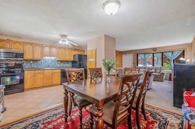 dining room featuring ceiling fan, a textured ceiling, and light tile patterned floors