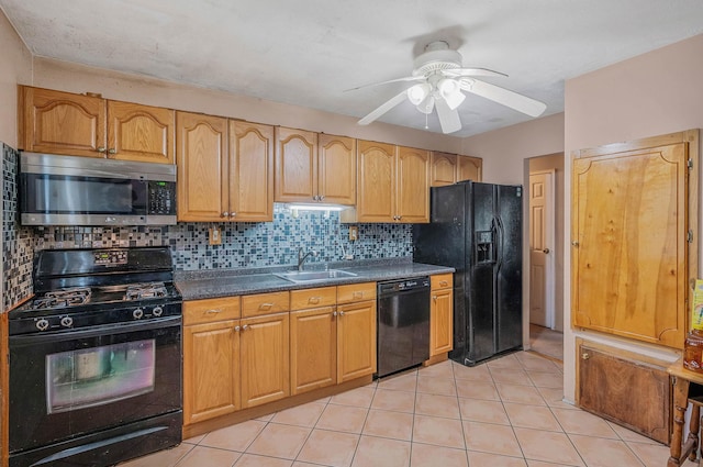 kitchen featuring black appliances, a sink, light tile patterned floors, and decorative backsplash