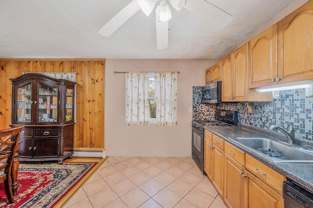 kitchen with black appliances, a sink, tasteful backsplash, dark countertops, and ceiling fan