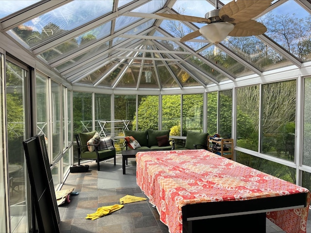 sunroom / solarium featuring a skylight, outdoor lounge area, and a ceiling fan