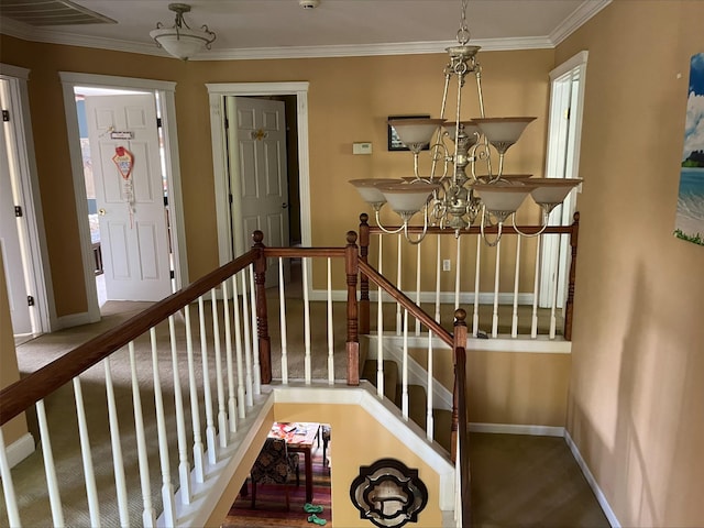 stairs with crown molding, baseboards, visible vents, and an inviting chandelier