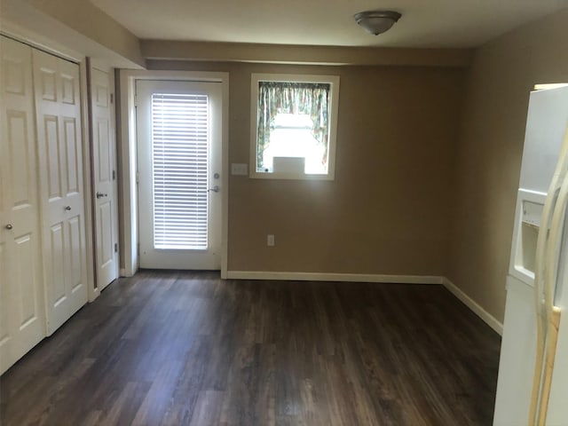 entryway featuring baseboards and dark wood-style floors
