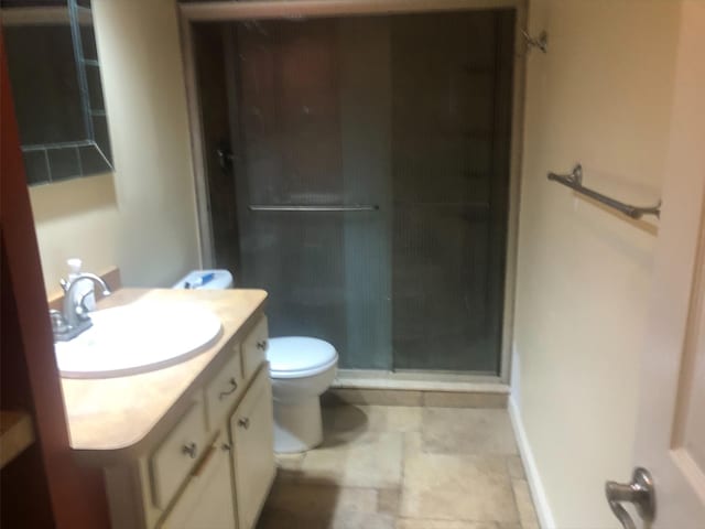 bathroom with toilet, a shower stall, and vanity